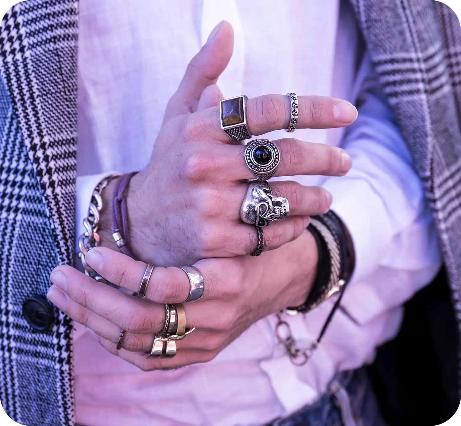 Hands with multiple rings and bracelets.