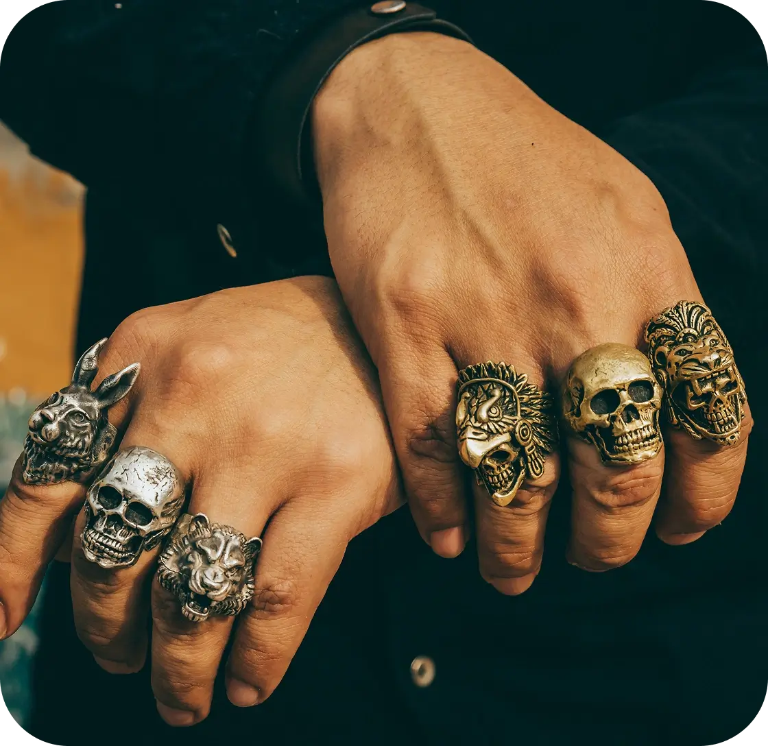 Hands wearing various decorative rings.