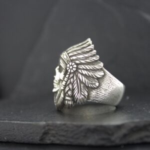 Silver ring with a detailed Native American headdress design.
