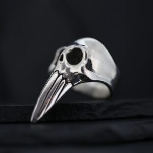 A silver ring shaped like a bird skull with a long beak.