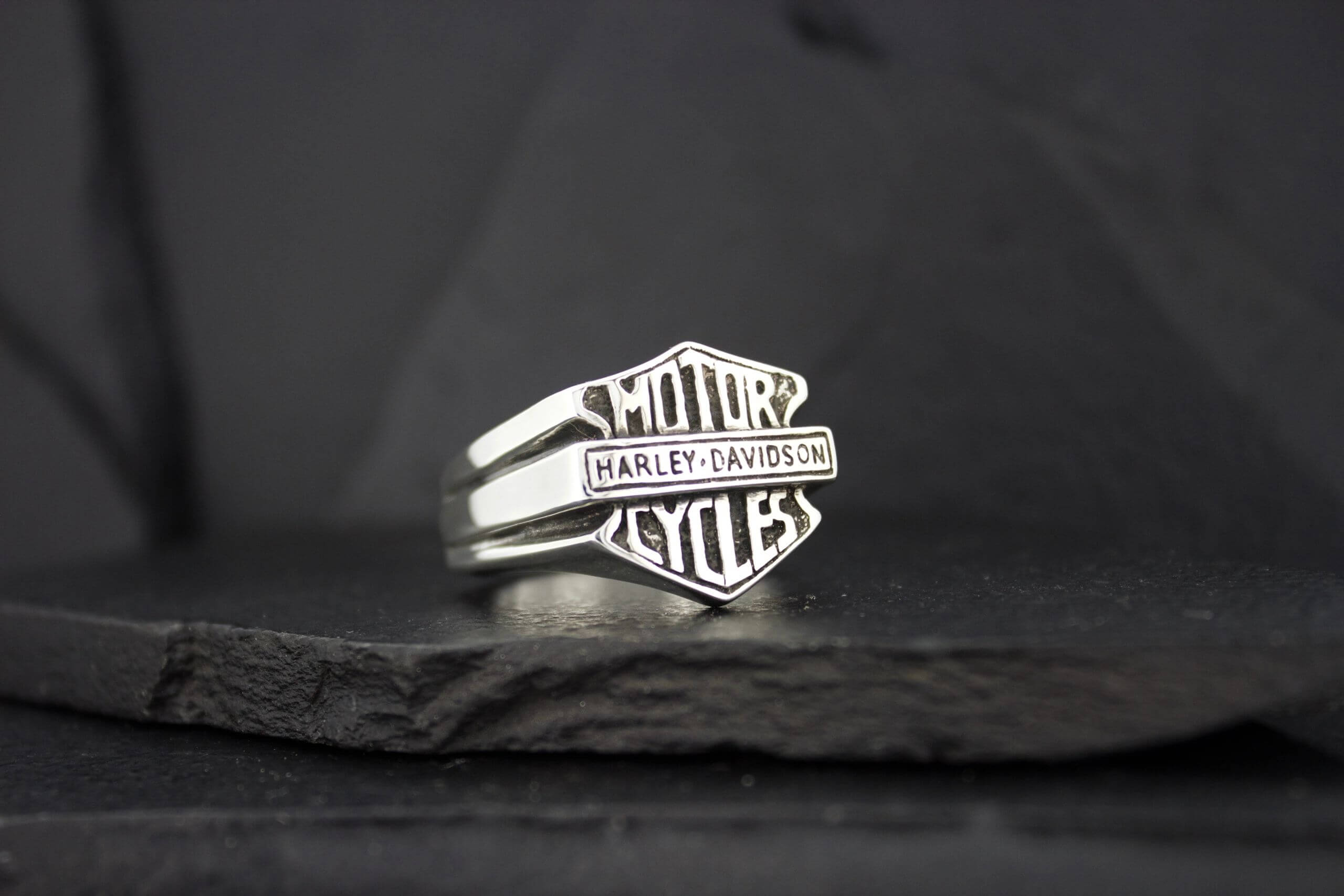 A sleek silver ring with 'AMOR' and 'KYLES' engraved on it.