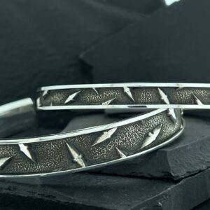 Close-up of metal tire chains with rugged tread pattern.