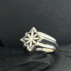 Elegant silver ring with a star-shaped design on top.