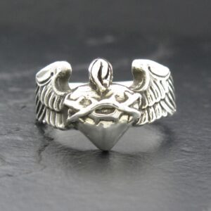 Silver ring with angel wings and a heart design.