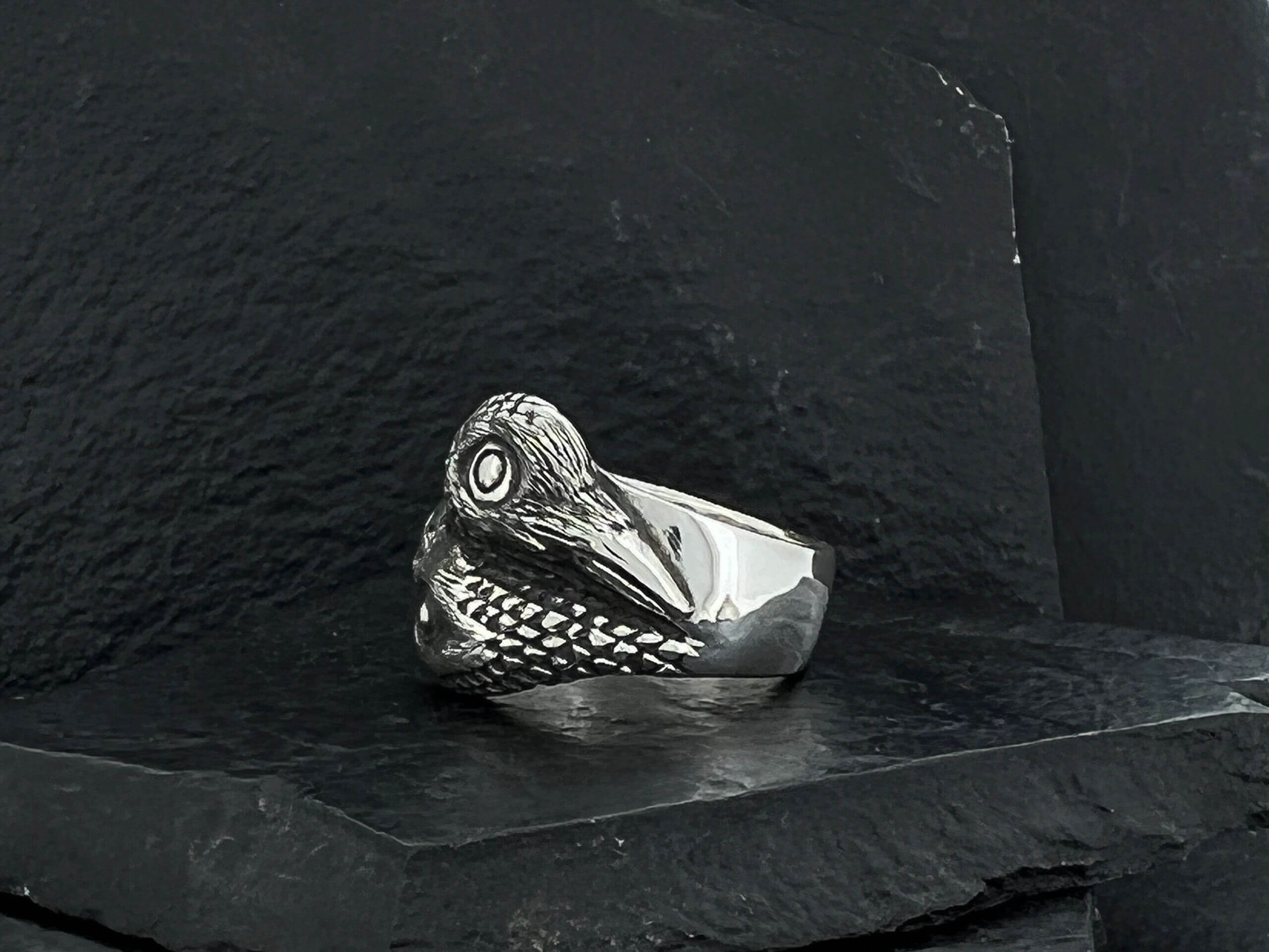 A silver ring designed as a crocodile head with detailed scales.