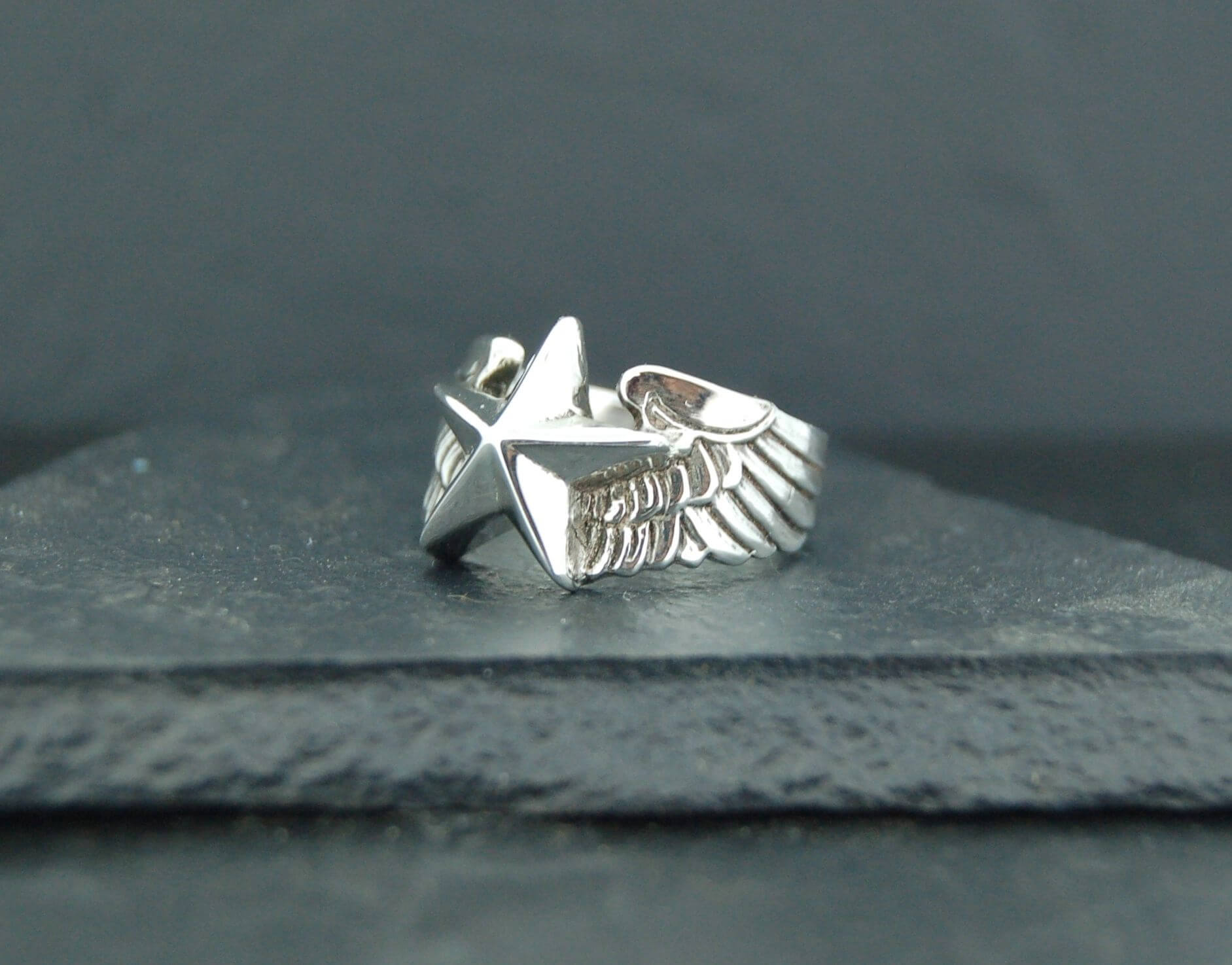Silver ring featuring an eagle design with spread wings.