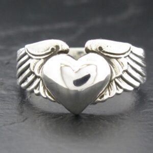 Silver ring with a heart and wings design.