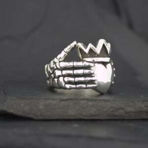 Silver ring shaped like a skeletal hand.