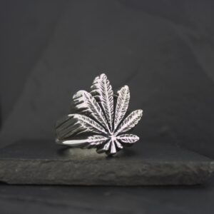 Silver ring featuring a detailed cannabis leaf design.