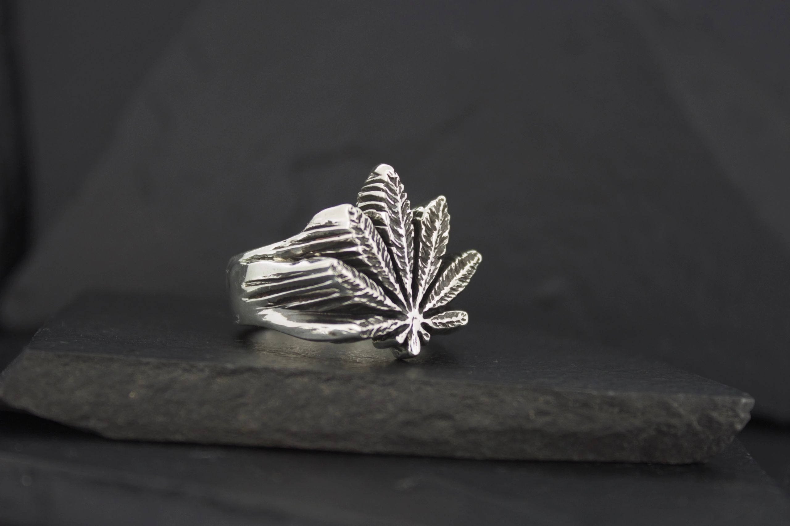 Silver ring shaped like a cannabis leaf.