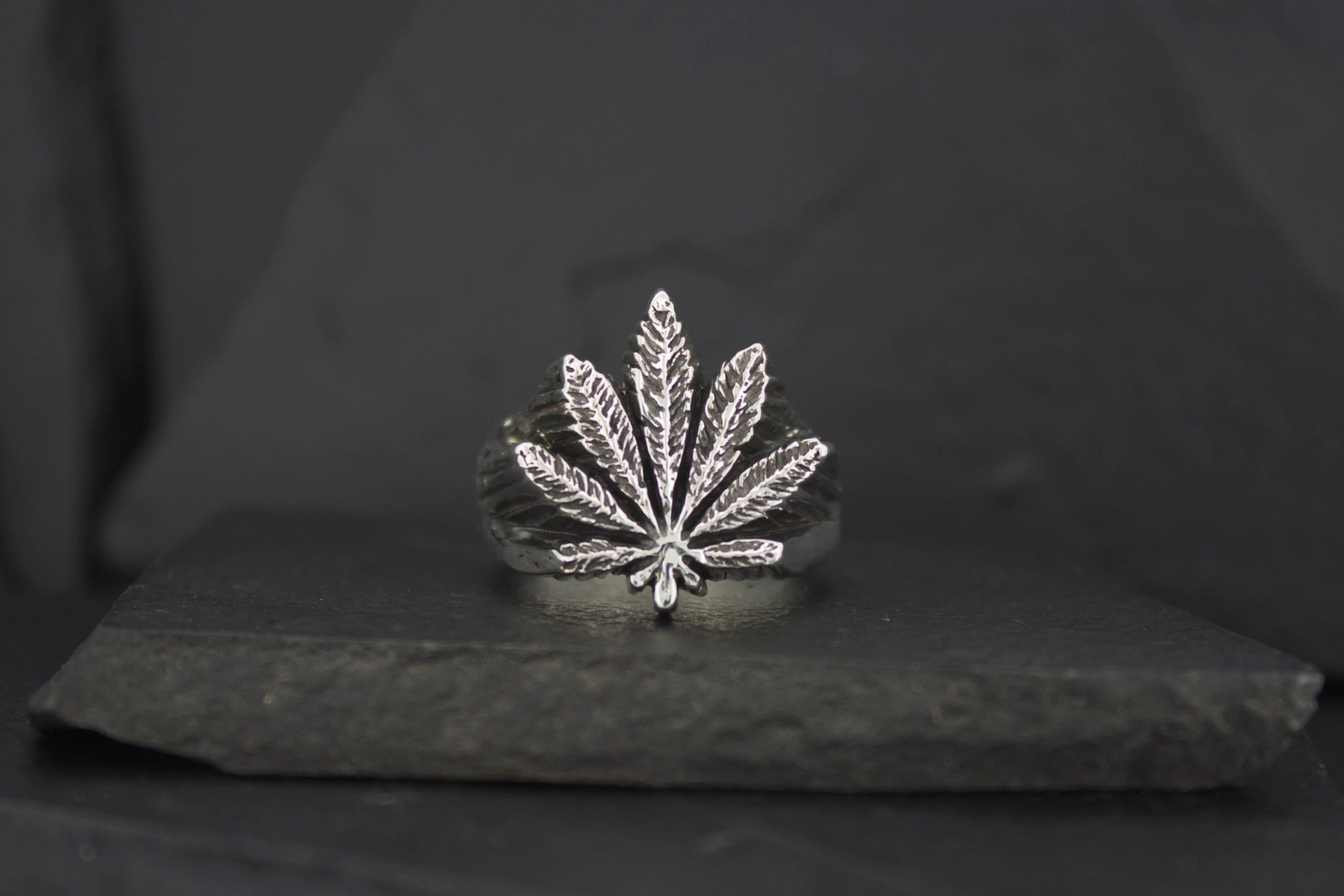 Silver ring shaped like a marijuana leaf.