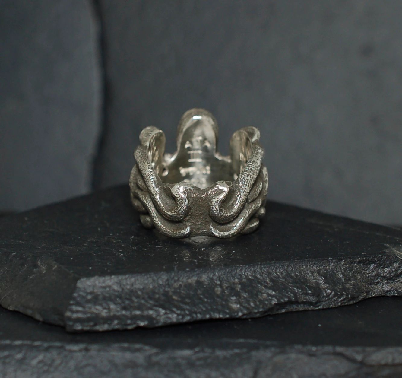 Intricately designed silver ring featuring an octopus motif.