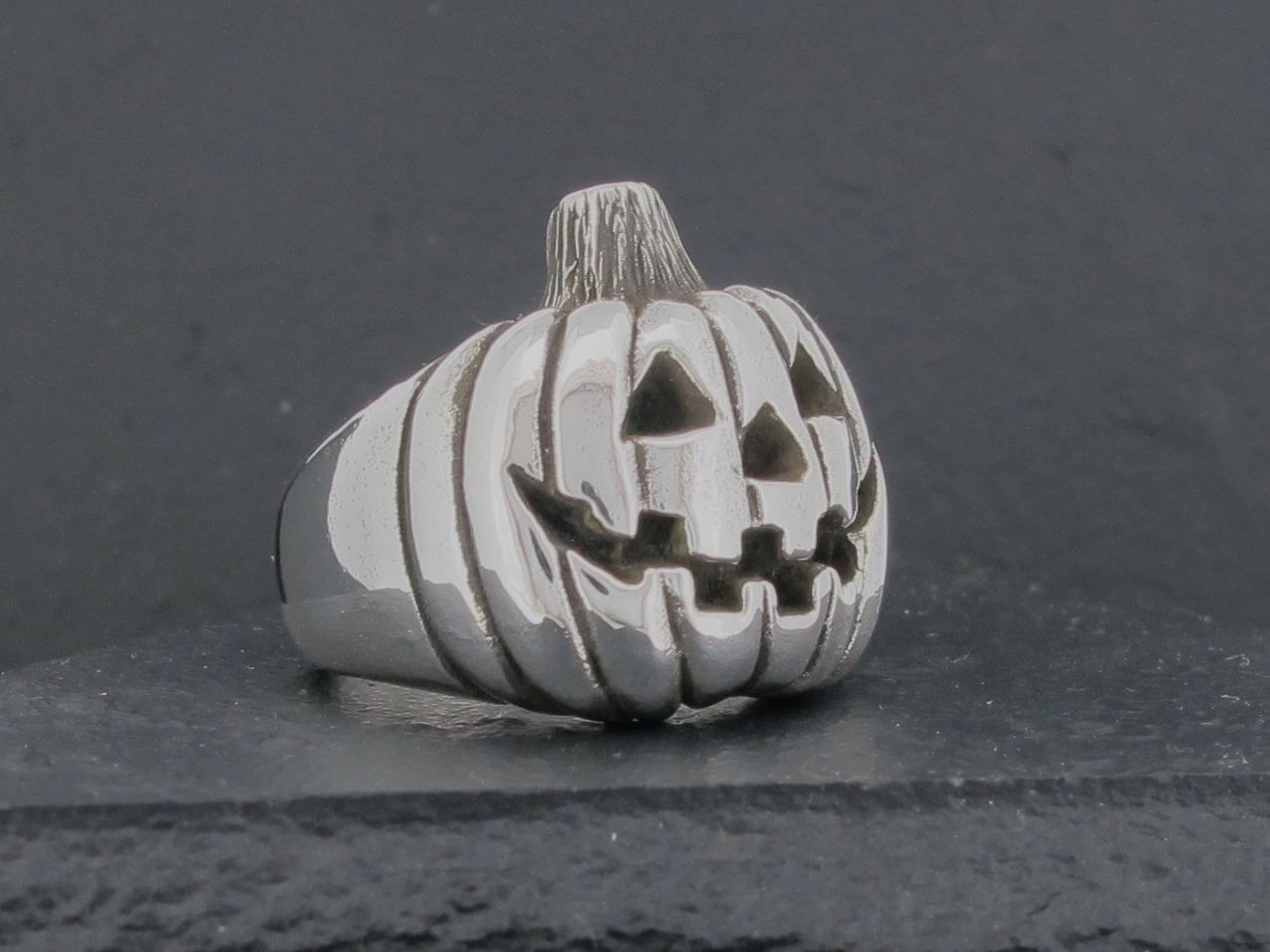 Silver ring shaped like a carved Halloween pumpkin.