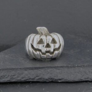 Silver pumpkin charm with a jack-o'-lantern face.