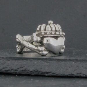 A small, detailed turtle-shaped charm or figurine on a dark surface.