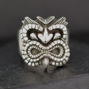 Intricately carved tribal-style ring with a bold design.