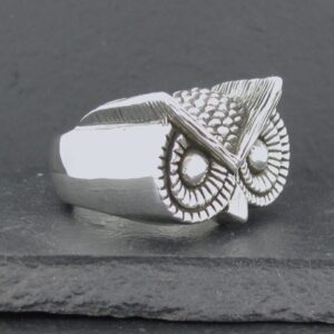 Silver owl-shaped ring with detailed feather design.