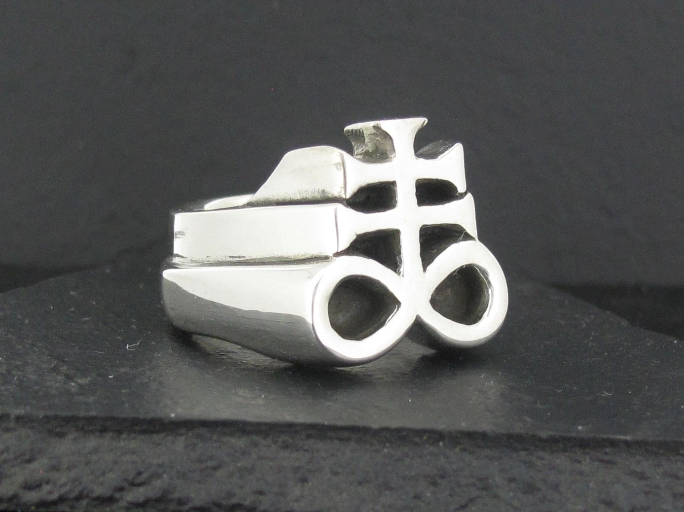 Silver ring with a unique, intricate symbol design.