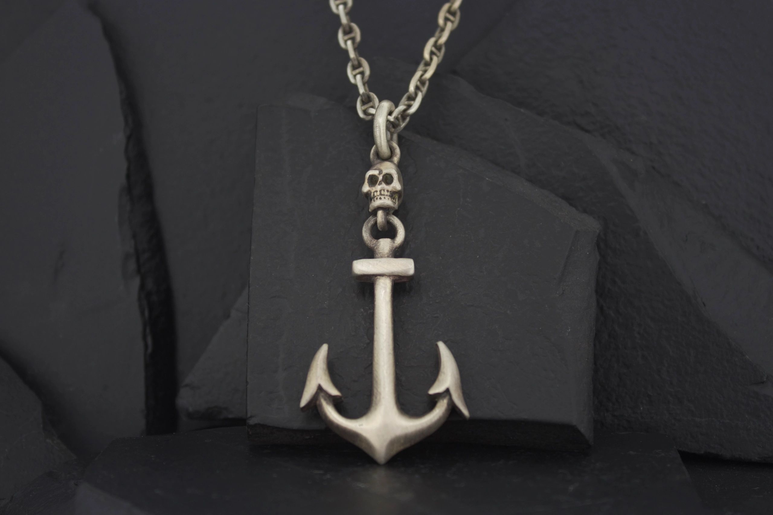 Silver anchor pendant on a chain necklace.
