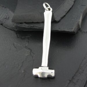Small silver hammer pendant on a textured dark surface.