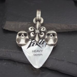 Silver pendant with two skulls and engraved text.