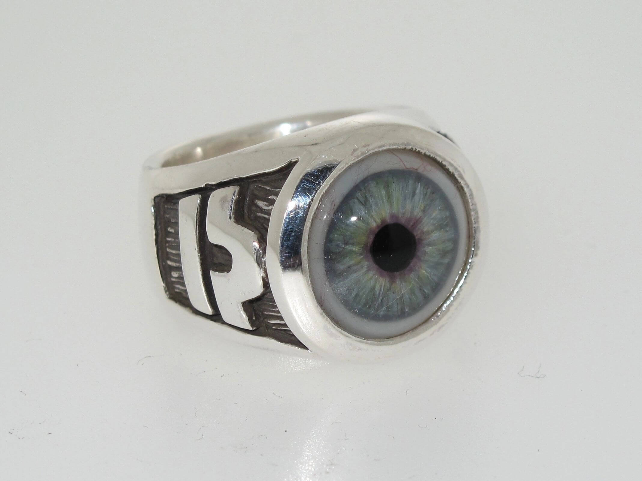 Silver ring with a realistic blue eye design.