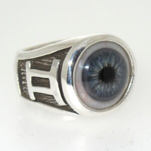 A silver ring with a detailed blue eye design on the top.
