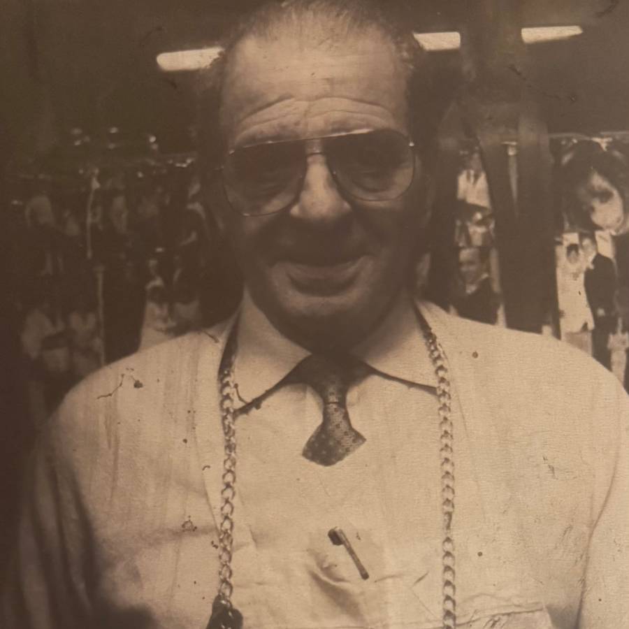Vintage photo of a man wearing glasses and a knitted sweater.