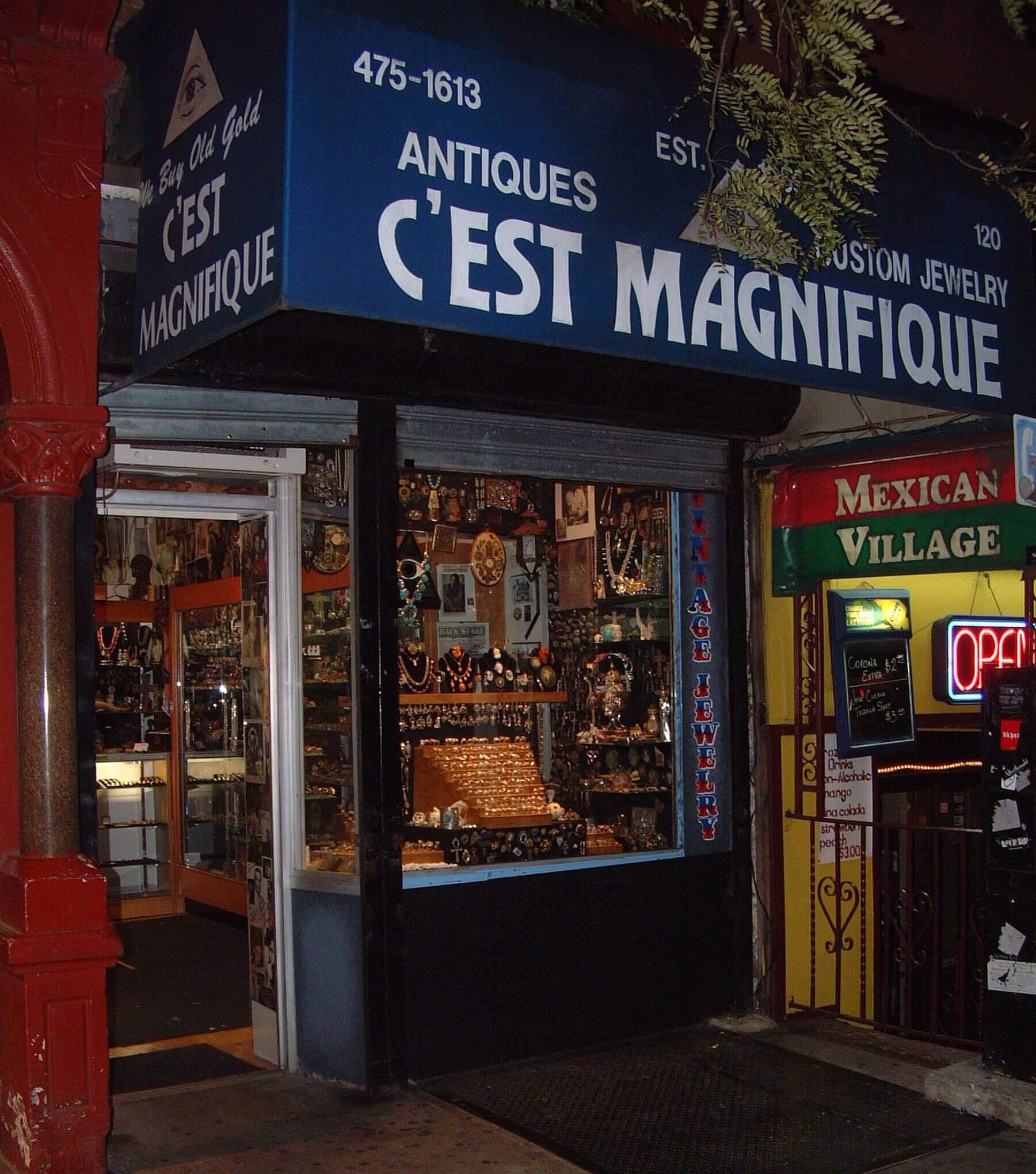 Cozy antique shop named 'C'est Magnifique' with warm lighting and vintage items.