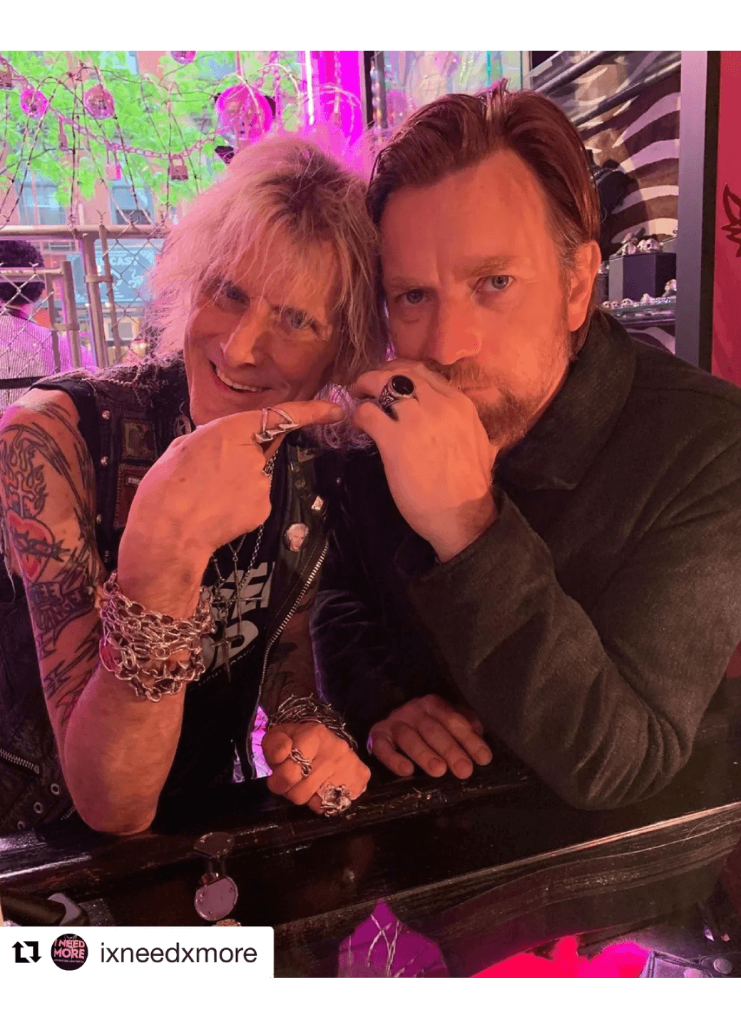 Couple sharing a cozy moment at a bar, hands intertwined.