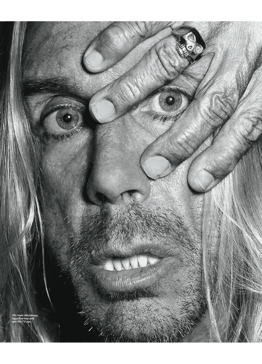 Close-up of a distressed man with hands covering parts of his face.
